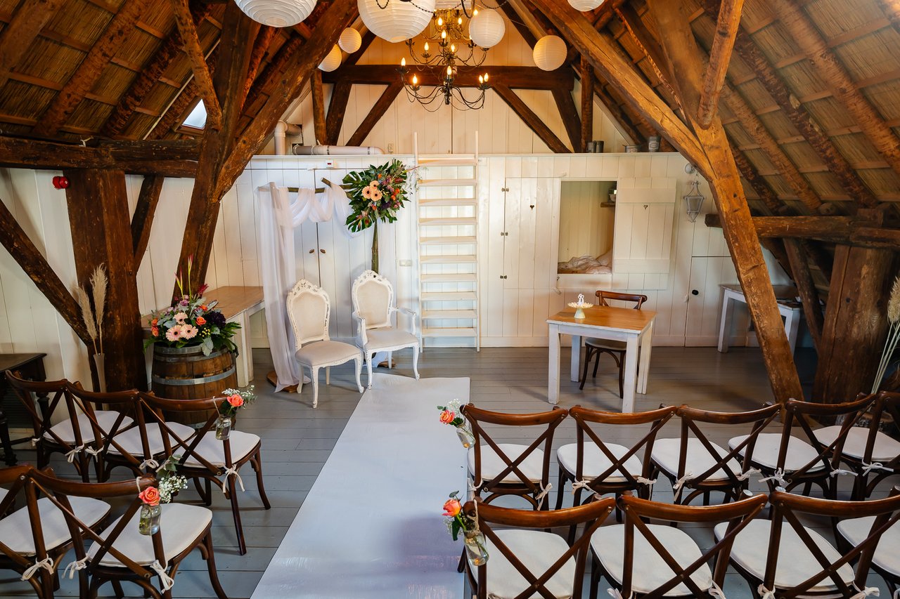 Vide ceremonie met witte trouwstoelen